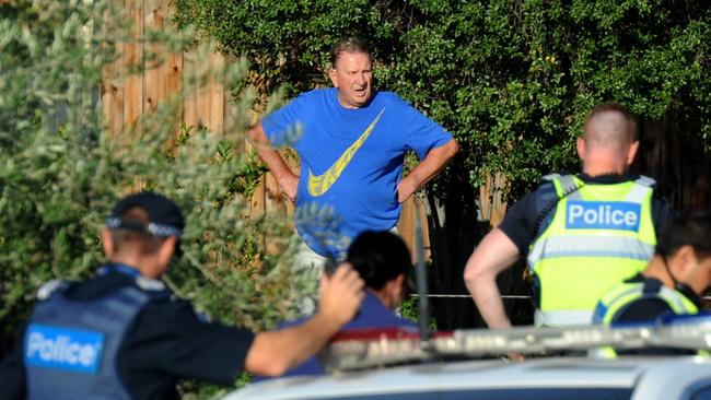 Police speak to a man at the scene of the crime. Picture: Andrew Henshaw