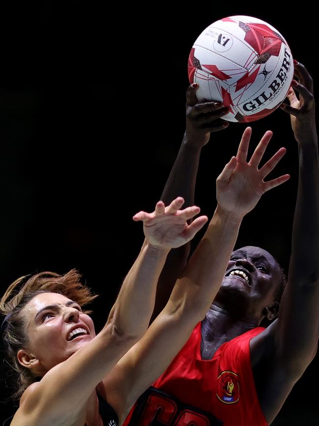 Cholhok of Uganda towers above six-foot New Zealand defender Karin Burger. Picture: Getty Images