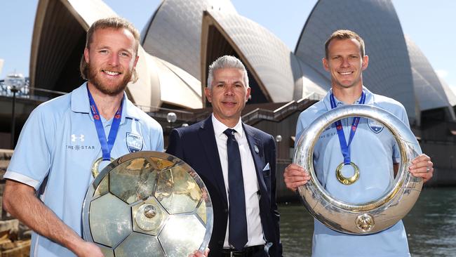 Champions: Rhyan Grant, Steve Corica and Alex Wilkinson pose with the A-League Premiers' Plate and A-League Trophy. Picture: Getty