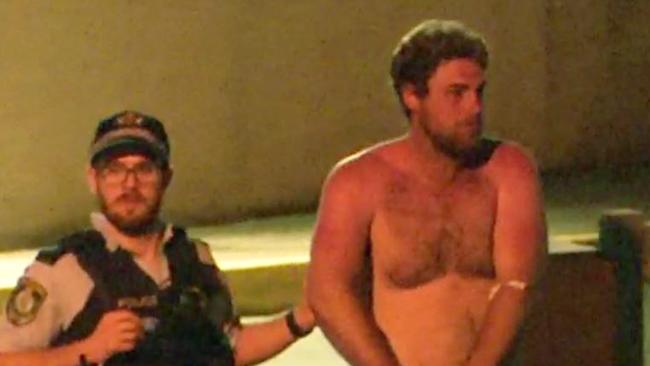 Samuel William Davidson is escorted by police. Picture: 7 News