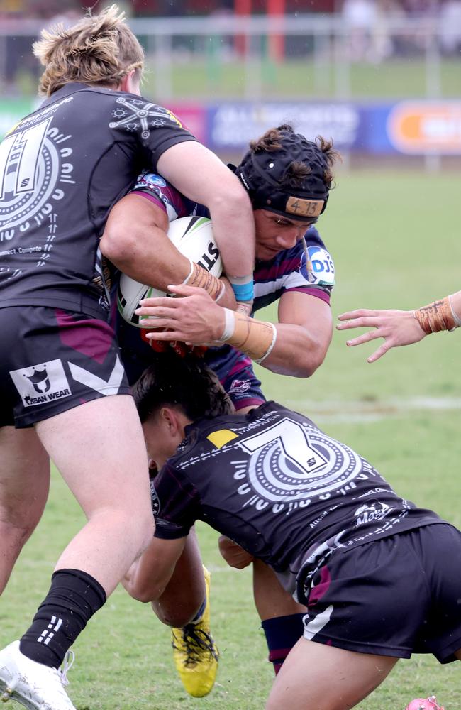 No.11 Zeke PETELO-PAULO with the ball from Ipswich SHS is tackled by Cody Coulter and Hayden Watson in the Langer clash.