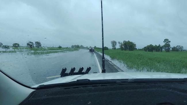 Flood waters submerge parts of the Bruce Highway at Midge Point towards Proserpine closing traffic in both directions.