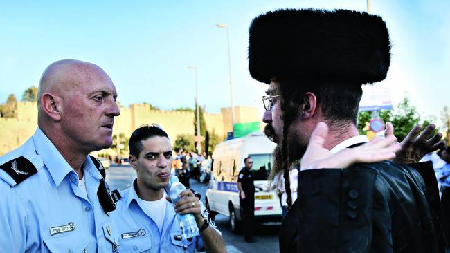 An orthodox Jew confronts police. Picture: Sylvie Le Clezio