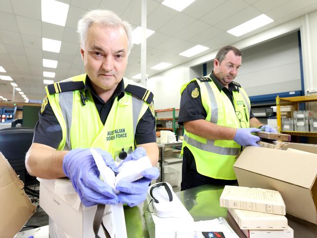 Border Force officers John (left) and Craig intercepting suspicious packages. Picture: Steve Pohlner