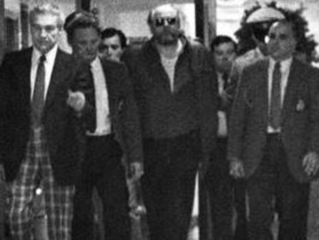 Kuklinski in custody surrounded by detectives and agents in 1986. Pic: Arty Pomerantz/New York Post