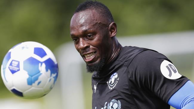 Usain Bolt trains for a charity match in England. Photo: Getty Images