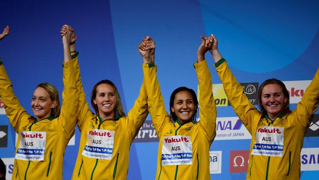 Bronze medallists Australia's Madison Wilson, Australia's Emma McKeon, Australia's Kotuku Ngawati and Australia's Ariarne Titmus celebrate on the podium of the women's 4x200m freestyle relay during the swimming competition at the 2017 FINA World Championships in Budapest, on July 27, 2017. / AFP PHOTO / Martin BUREAU