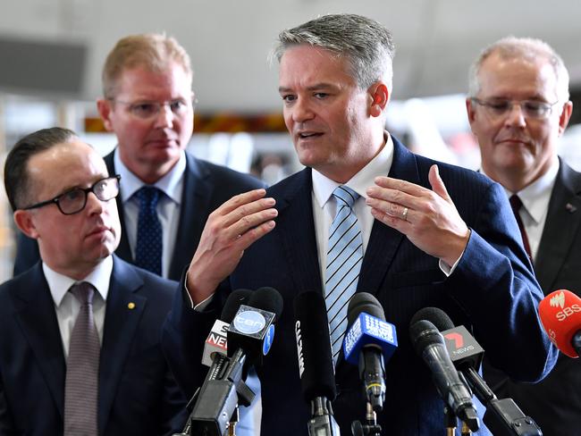 (L-R) Qantas CEO Alan Joyce, Assistant Minister for Multicultural Affairs Craig Laundy, Acting Prime Minister Senator Mathias Cormann and Federal Treasurer Scott Morrison speak at the Qantas Hanger at Sydney Domestic Airport in Sydney, Friday, February 23, 2018. (AAP Image/Joel Carrett)  NO ARCHIVING