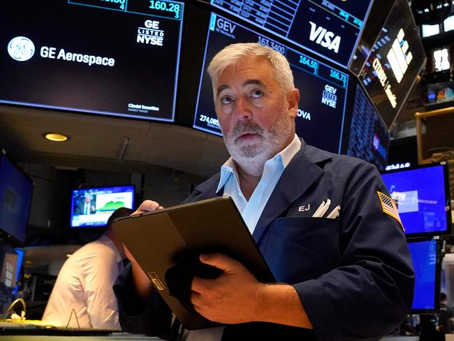 A trader works on the floor of the New York Stock Exchange (NYSE) in New York City on July 22, 2024. Wall Street stocks opened higher early Monday as tech shares bounced back after a recent pullback, as investors looked ahead to major earnings and economic data due this week. The US presidential race had produced a surprise over the weekend with Joe Biden bowing out of the race and throwing support to Vice President Kamala Harris. (Photo by TIMOTHY A. CLARY / AFP)