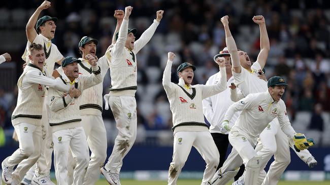 As the last wicket falls, Australian players celebrate victory in the fourth Test at Old Trafford, a win that ensured they retained the Ashes. Picture: Getty Images