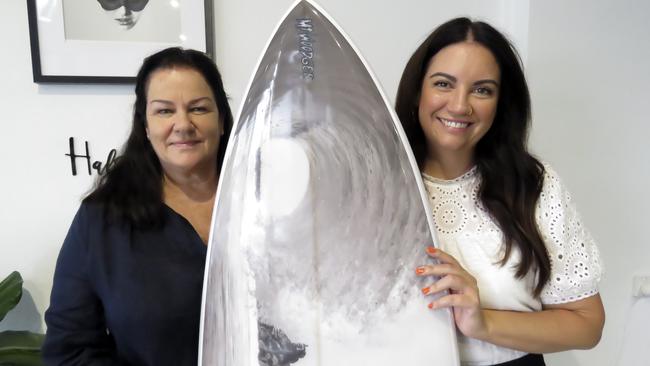 Judy Littler (left) won a custom made Mt Woodgee surf board, among other prizes, after buying tickets for a fundraiser to support wildlife organisations supporting bushfire affected animals. Rachel Hannah (right) was just one of 12 salons across the Tweed and Gold Coast who organised the event.