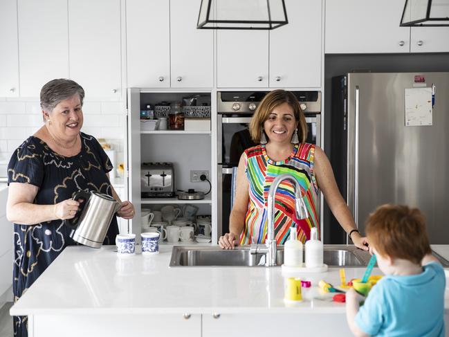 Lyn and Megan watch over Max, 3, as he plays in the kitchen. Picture: Mark Cranitch.