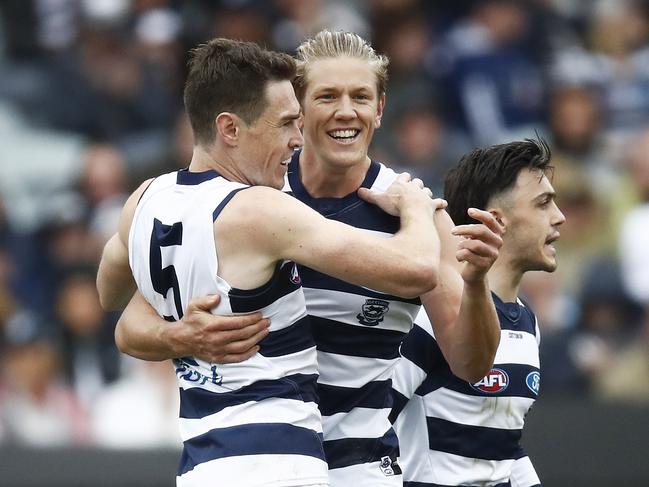 Jeremy Cameron (L) won’t forget his first game for the Cats any time soon.