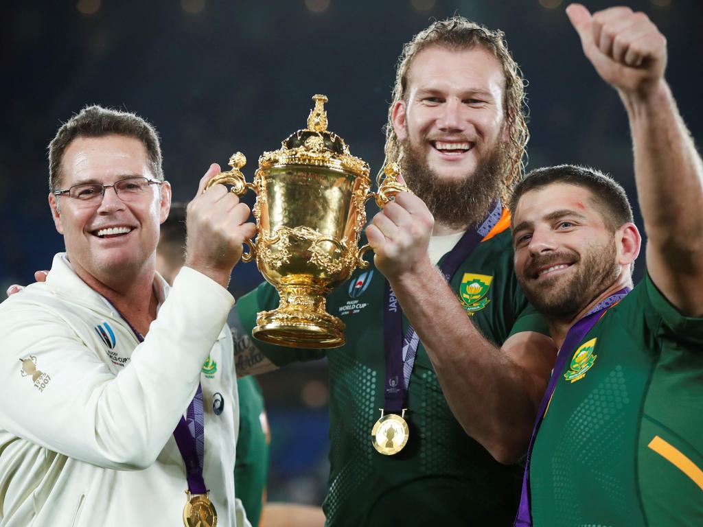 South Africa's head coach Rassie Erasmus (L) lifts the Webb Ellis Cup with South Africa's lock RG Snyman (C) and South Africa's full back Willie Le Roux as they celebrate winning the Japan 2019 Rugby World Cup final match between England and South Africa at the International Stadium Yokohama in Yokohama on November 2, 2019. (Photo by Odd ANDERSEN / AFP)