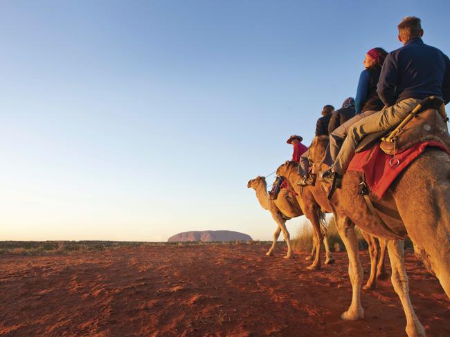 Saddling up ... Tourists on a camel tours in the red centre. Pic: Tourism NT