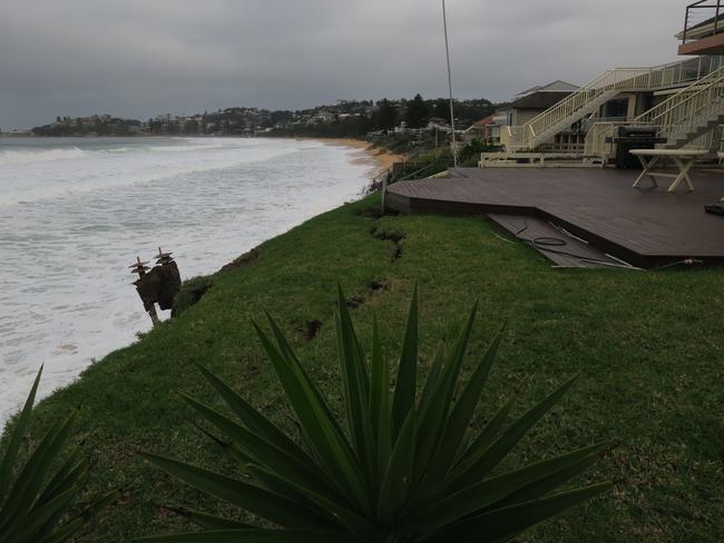 A large crack is opening up in the backyard of a Wamberal property badly affected by erosion. Residents fear this section will collapse next. Picture: Richard Noone