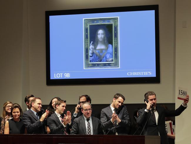 Bidding representatives react after the Leonardo da Vinci sold for a world record price.