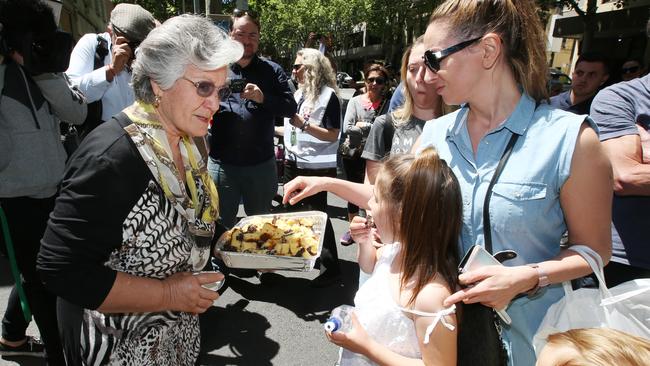 Lucia, who has worked at Pelligrini’s for 18 years, hands out Sisto’s favourite chocolate and almond cake. Picture: Michael Klein