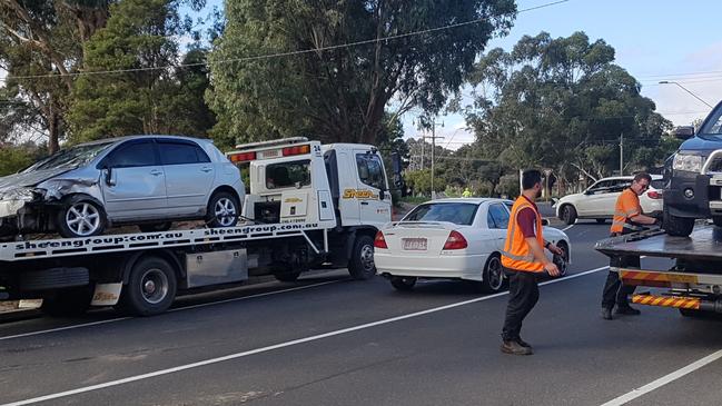 Two cars are loaded onto trailers in Croydon Hills Drive following a rollover on July 14. Picture: Kiel Egging.