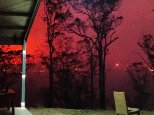 The fire turned the sky red as it approached homes. Photo: Facebook/NSW Incidents