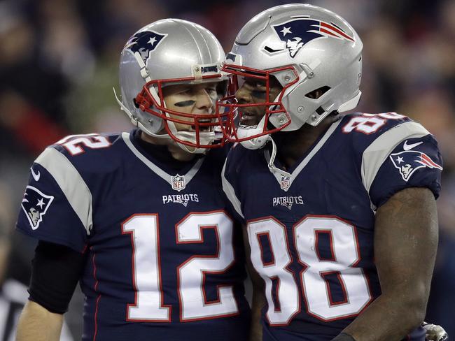 New England Patriots quarterback Tom Brady (12) celebrates his touchdown pass to tight end Martellus Bennett (88) during the second half of an NFL football game against the Baltimore Ravens, Monday, Dec. 12, 2016, in Foxborough, Mass. (AP Photo/Charles Krupa)