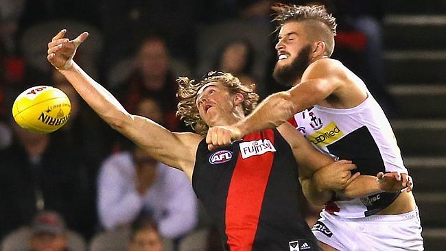 Josh Bruce punches the ball away from Joe Daniher.