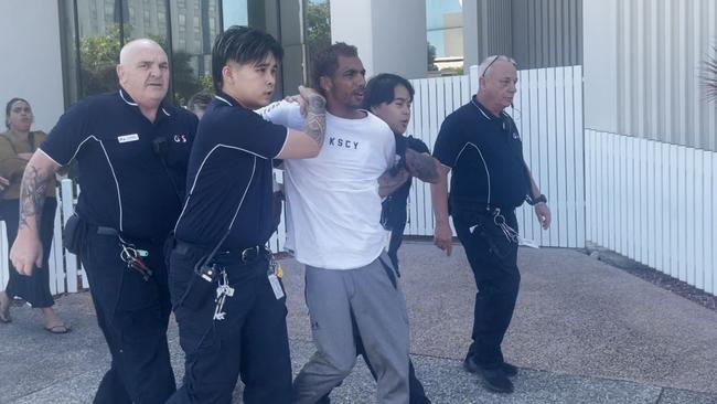 Ezra Austral was restrained by security after evading G4S court security, jumping over the barrier and running down the street at Darwin Local Court on Thursday, May 29. Picture: Zizi Averill