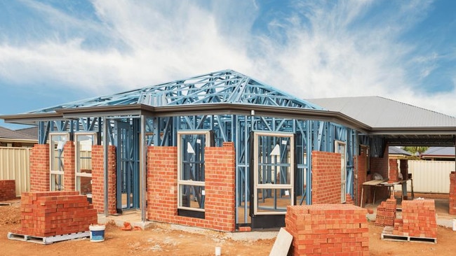 New residential construction home from brick with metal framing against a blue sky; real estate Australian generic suburban homes