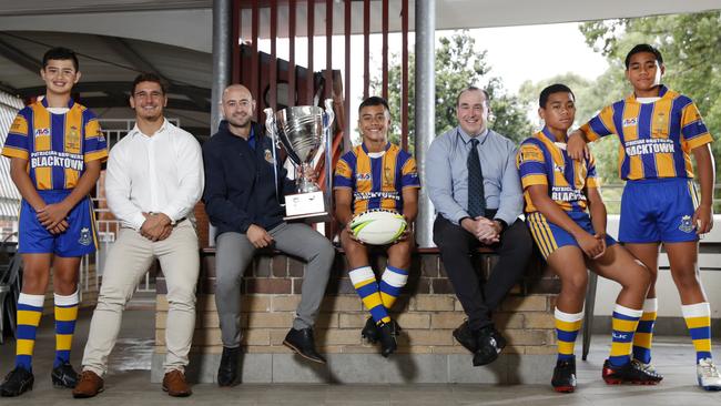 Patrician Brothers Blacktown has produced a huge number of NRL stars and are the reigning NRL Schoolboy Cup champions. Football coaches Joseph Tramontana, Noah Meares and Greg Beacroft with Year 7 players from left Tyrone Moeroa, 12, Calvary Luai, 12, and Alexander and twin brother Cornelius Pupualii, 12. Picture: Jonathan Ng