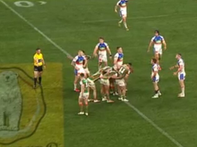 The referee points to the mark, well behind the Rabbitohs.