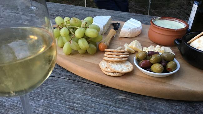 Wine and a nibbles platter is served at Par Avion's standing wilderness camp at Bathurst Harbour near Port Davey. Picture: JOANNE YOUNG