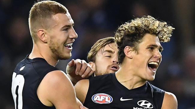 Charlie Curnow celebrates a goal with fellow key forward Harry McKay.