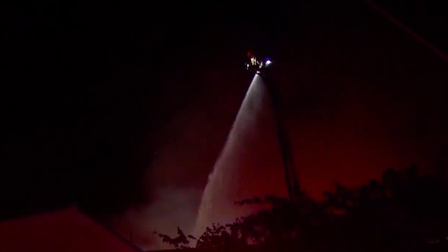 Firefighters dump water on the blaze from a crane. Picture: Today/9 News