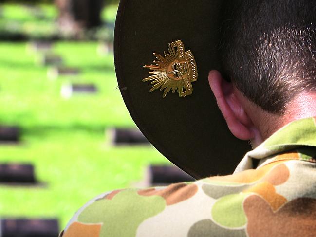 Sapper Joshua Knox from 2nd Combat Engineer Regiment pays respects while his 'rising sun' badge sits over a soldier's tombstone at Ambon war cemetery, Indonesia during Pacific Partnership 2010. Commonwealth and United States Defence personnel visited Ambon war cemetery in Indonesia during a recent break in Pacific Partnership 2010 activities. The cemetery, built on the site of a former camp for British, Dutch and Australian prisoners of war, has over 2000 graves with more than half of those being Australian.