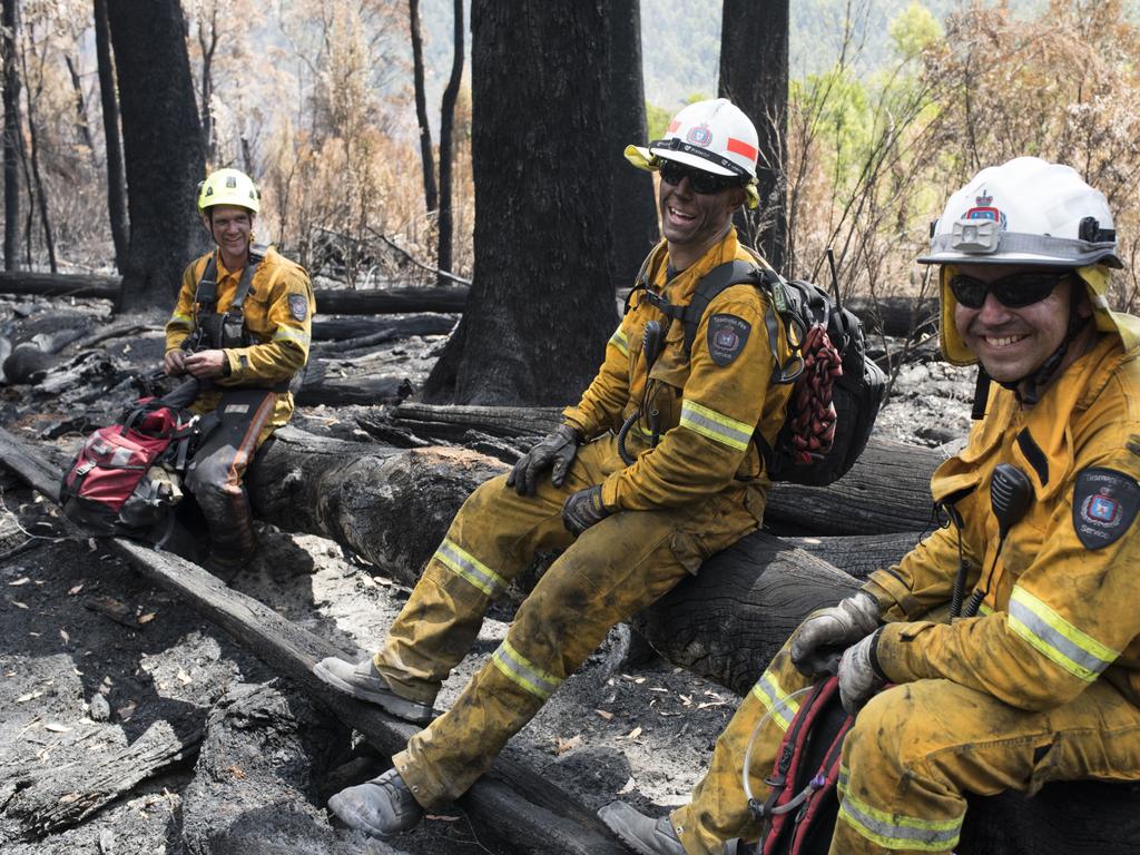 Gell River firefighters Simon Pilkington, left, Drummond Williamson and Anthony Cowles take a well-earned break. Picture: WARREN FREY/TASMANIA FIRE SERVICE