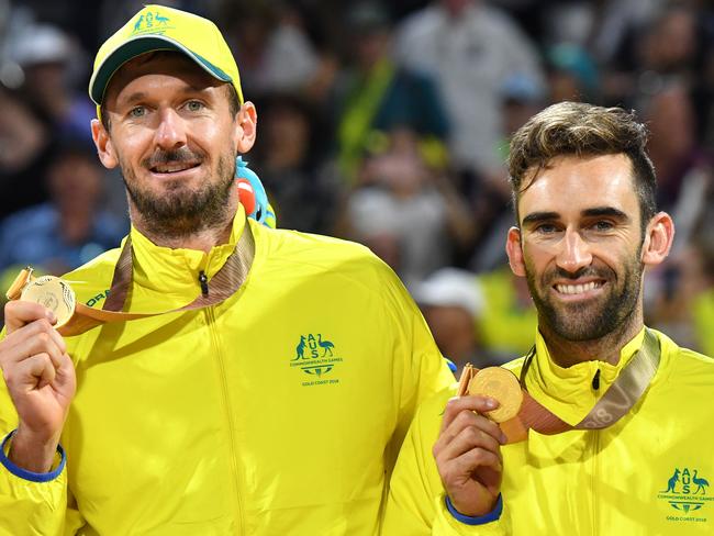 Damien Schumann (left) and Christopher McHugh (right) of Australia celebrate winning the gold medal against Samuel Pedlow and Sam Schachter of Canada during the mens Beach Volleyball Gold Medal match at Coolangatta Beach on day eight of the XXI Commonwealth Games on the Gold Coast, Australia, Thursday, April 12, 2018. (AAP Image/Darren England) NO ARCHIVING, EDITORIAL USE ONLY