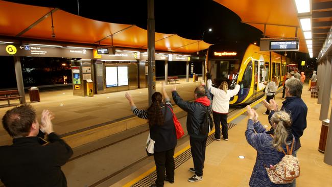 People cheered as the first tram rolls in the station. Picture by Scott Fletcher