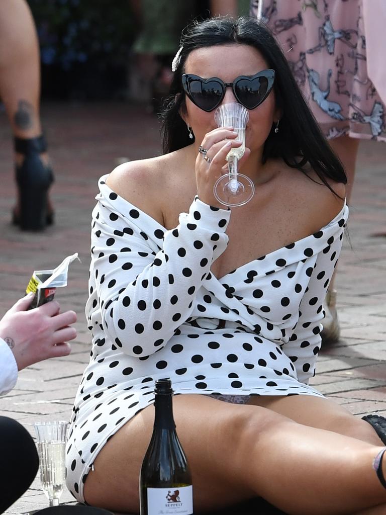 A punter takes a breather and rests those feet. Picture: Julian Smith/AAP