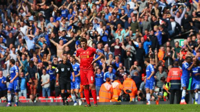 A dejected Steven Gerrard of Liverpool looks on as the Chelsea fans celebrate.