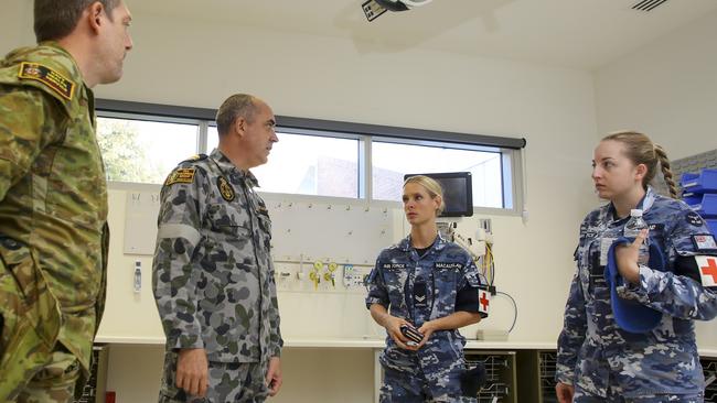 Australian Defence Force health professionals discuss the day's schedule in the North West Regional Hospital in Burnie Tasmania, after the hospital's formal handover from contracted cleaning personnel, during the COVID-19 pandemic.