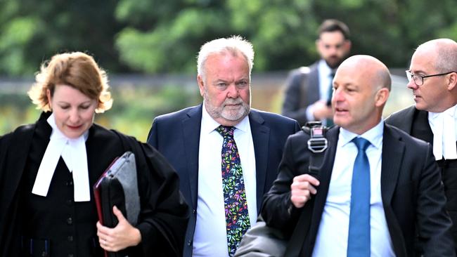 Former Queensland Health Metro North Hospital and Health Service chief executive Malcolm Stamp (centre) is facing a committal hearing over allegations he allegedly attempted to give his daughter a job via a taxpayer-funded contract. Picture: NCA NewsWire / Dan Peled