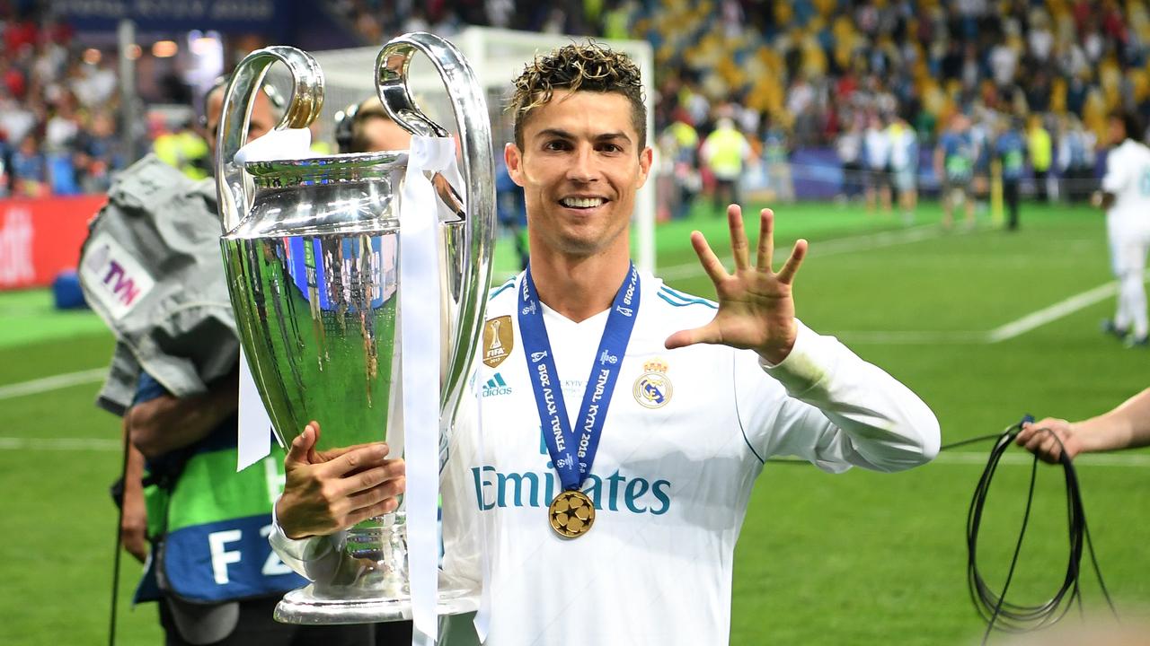 Cristiano Ronaldo lifts the Champions League trophy for the fifth time with Real Madrid.