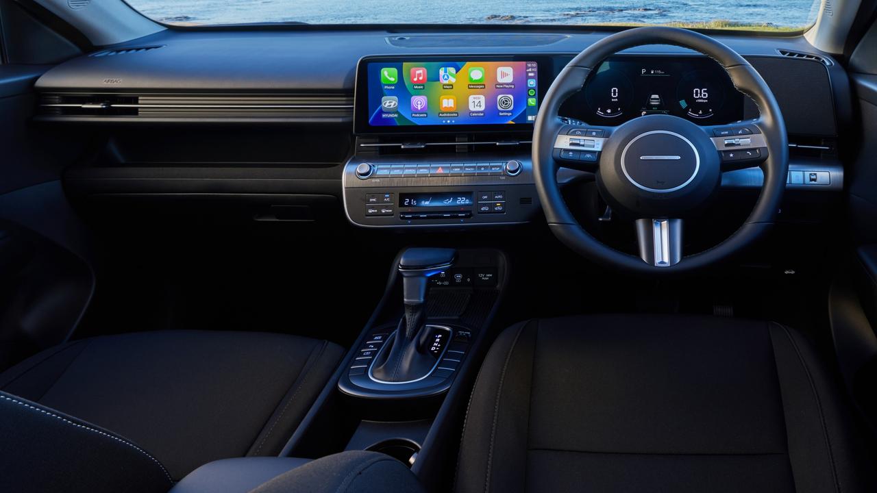 Interior features of the base model 2023 Hyundai Kona include a large touchscreen with Apple CarPlay and Android Auto, along with a digital driver display.