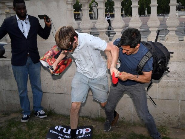 Pro- and anti-Trump protesters tussle outside Buckingham Palace as Donald Trump attended a state dinner with the Queen. Picture: Getty