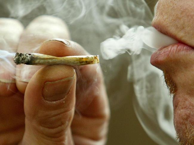 MAY 27, 2003 : A man smokes marijuana recreationally in Toronto, 27/05/03. The federal government moved to eliminate criminal penalties for simple possession of marijuana, but promised a tougher line against growers and dealers.Canada / Crime / Drug / Smoking / Cannabis / Generic / Joint