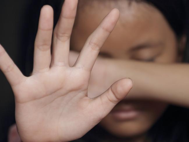 Little girl suffering bullying raises her palm asking to stop the violence