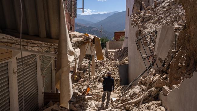 A man walks amongst the rubble of collapsed buildings in Moulay Brahim, Morocco. Picture: Getty Images