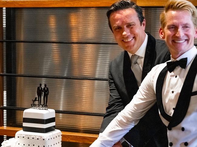 Damien Anthony Rossi (now Avery-Rossi) and Jason Avery (now Avery-Rossi) cut their wedding cake, designed by Cakes by JudyC. Picture: Thomas Oliver