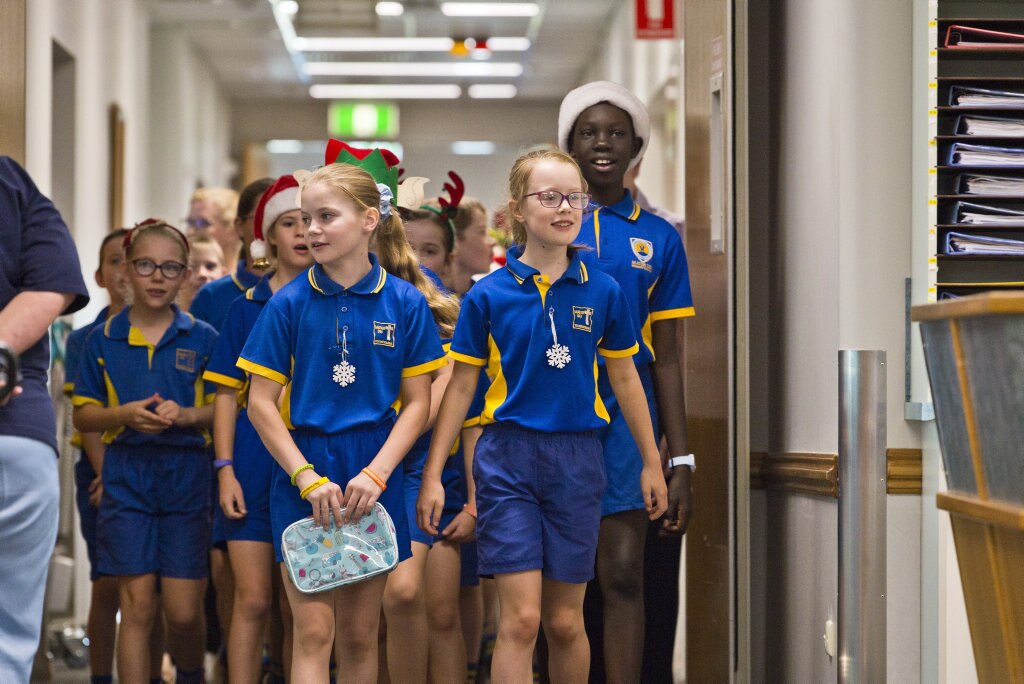 Leading the group are Chloe Wright (left) and Sophie Wood as Mater Dei Primary School Yr 4 students sing Christmas carols in the wards of St Vincent's Private Hospital, Friday, November 29, 2019. Picture: Kevin Farmer