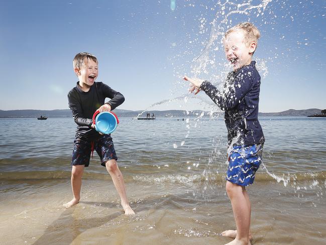 Brothers Harry, 7, and Charlie Rose, 5, of Sandy Bay, cool off at Long Beach. Picture: ZAK SIMMONDS